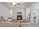 Open concept space with fireplace and modern decor; kitchen and eating area are visible in the background at 2235 Mulsanne Dr, Lithonia, GA 30058
