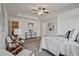 Bright main bedroom with tray ceiling, carpet flooring, ceiling fan, and sitting area at 2235 Mulsanne Dr, Lithonia, GA 30058
