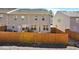 Fenced backyard of a townhouse featuring a well-maintained lawn and rear entry at 2240 Mulsanne Dr, Lithonia, GA 30058