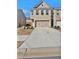 Street view of a two-story townhome with a brick front and a two-car garage at 2240 Mulsanne Dr, Lithonia, GA 30058