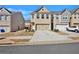 Two-story townhome with brick facade and two-car garage on a sunny day at 2240 Mulsanne Dr, Lithonia, GA 30058