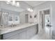 Bathroom features double vanity, granite counters, modern fixtures, and an adjacent shower and bath at 2304 Isla Run Run, Woodstock, GA 30188