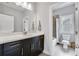 Neutral bathroom featuring dark cabinetry with a granite countertop and a framed mirror at 2304 Isla Run Run, Woodstock, GA 30188