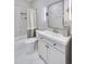 Modern bathroom with large vanity, white marble floors, shower and tub at 2304 Isla Run Run, Woodstock, GA 30188