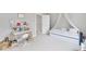 bedroom featuring a canopy bed, art supplies, and a study desk with a modern white chair at 2304 Isla Run Run, Woodstock, GA 30188