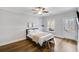 Cozy bedroom with hardwood floors, ceiling fan, natural light, and direct access to the deck at 2304 Isla Run Run, Woodstock, GA 30188