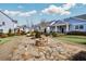 Community fire pit and gathering area surrounded by beautifully landscaped homes and gardens at 2304 Isla Run Run, Woodstock, GA 30188