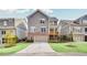 View of the rear of a two-story home with garage and covered porch; professionally landscaped yard at 2304 Isla Run Run, Woodstock, GA 30188