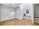 Bright foyer with hardwood floors, white walls, staircase and modern console table at 2304 Isla Run Run, Woodstock, GA 30188