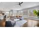 Open-concept living room with hardwood floors, recessed lighting, and large windows offering natural light at 2304 Isla Run Run, Woodstock, GA 30188