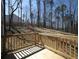 Back deck with wood railing and trees in the background at 250 Shawnee Trl, Dallas, GA 30157
