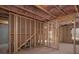 Unfinished basement with exposed wood studs, pink insulation, and natural light at 250 Shawnee Trl, Dallas, GA 30157
