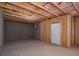 Unfinished basement with a concrete floor, pink insulation, and a white door at 250 Shawnee Trl, Dallas, GA 30157