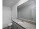 Bathroom featuring a granite countertop, spacious mirror, and combination shower and tub at 250 Shawnee Trl, Dallas, GA 30157