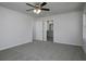 Bedroom featuring neutral carpet, ceiling fan, natural light, and an ensuite bathroom with granite countertops at 250 Shawnee Trl, Dallas, GA 30157