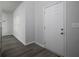 Neutral entryway featuring a white door and light flooring, with sunlight streaming through the nearby window at 250 Shawnee Trl, Dallas, GA 30157