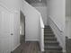 Bright foyer showcasing staircase with white railing and a glimpse into other rooms with modern, light flooring at 250 Shawnee Trl, Dallas, GA 30157
