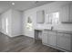 Bright eat-in kitchen featuring gray cabinetry, wood-look floors, and natural light at 250 Shawnee Trl, Dallas, GA 30157