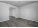 Minimalist living room featuring light gray floors, white walls, and a glimpse into the dining area at 250 Shawnee Trl, Dallas, GA 30157