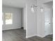 Open-concept living room showcases modern lighting and gray-toned flooring, creating a welcoming space at 250 Shawnee Trl, Dallas, GA 30157