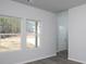 Bright living room with gray floors, white walls, and natural light pouring through the windows at 250 Shawnee Trl, Dallas, GA 30157