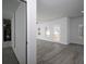 Spacious, neutrally decorated living room showcasing sunlight and modern flooring at 250 Shawnee Trl, Dallas, GA 30157