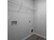 Utility room with white wire shelving, hookups, and wood-look flooring at 250 Shawnee Trl, Dallas, GA 30157