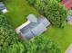 Birds-eye view of the home showing its roof, expansive lawn, driveway, and the surrounding mature trees at 414 Landers Sw Dr, Mableton, GA 30126