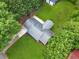 Aerial view of the home showcasing its roof, driveway, mature trees, and spacious surrounding yard at 414 Landers Sw Dr, Mableton, GA 30126