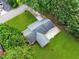 Aerial view of the property featuring the roof, driveway, lush lawn, and mature trees surrounding the home at 414 Landers Sw Dr, Mableton, GA 30126