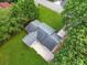 Overhead view of the home showing the roof, surrounding green lawn, mature trees, and extended driveway at 414 Landers Sw Dr, Mableton, GA 30126