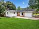 Home exterior featuring a well-maintained lawn, a concrete patio, and a bright, white exterior addition at 414 Landers Sw Dr, Mableton, GA 30126