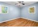 Sunny bedroom with hardwood floors and two bright windows at 414 Landers Sw Dr, Mableton, GA 30126
