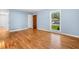 Bedroom with blue walls, hardwood floors, and natural light from a large window at 414 Landers Sw Dr, Mableton, GA 30126