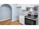 Updated kitchen featuring granite countertops, stainless steel appliances, and an arched entryway at 414 Landers Sw Dr, Mableton, GA 30126