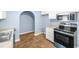 Kitchen featuring granite countertops, stainless steel appliances, and an arched entryway at 414 Landers Sw Dr, Mableton, GA 30126