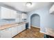 Charming kitchen with white cabinetry, stone countertops, stainless steel sink and stainless steel dishwasher at 414 Landers Sw Dr, Mableton, GA 30126