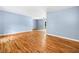 Bright living room with blue walls, hardwood floors, and natural light from a glass door at 414 Landers Sw Dr, Mableton, GA 30126