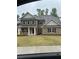 New construction home with brick facade, a covered porch and manicured lawn at 5000 Fairview Cir, Villa Rica, GA 30180