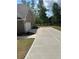 Side view of a home featuring a driveway and two-car garage with a paved driveway at 5000 Fairview Cir, Villa Rica, GA 30180