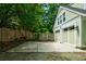 Backyard view featuring a two-car garage with lush landscaping and a wood privacy fence at 630 Cleburne Ne Ter, Atlanta, GA 30306