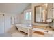 Bright bathroom featuring a soaking tub, vanity area, and white subway tile throughout at 630 Cleburne Ne Ter, Atlanta, GA 30306