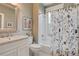 Bathroom featuring a tub and shower with a floral shower curtain, sink, and medicine cabinet with artwork on the wall at 630 Cleburne Ne Ter, Atlanta, GA 30306