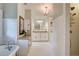 Bright bathroom featuring a bathtub, tiled shower, vanity area, and white cabinetry for storage at 630 Cleburne Ne Ter, Atlanta, GA 30306