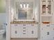 Bathroom featuring double sinks, large mirror, white cabinets, and a separate toilet room at 630 Cleburne Ne Ter, Atlanta, GA 30306