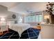 Comfortable bedroom with large windows, wood floors, a blue patterned rug, and stylish decor at 630 Cleburne Ne Ter, Atlanta, GA 30306