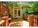 Beautiful outdoor deck with a grill, seating, plants, and access to the home's interior via French doors at 630 Cleburne Ne Ter, Atlanta, GA 30306