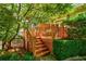 Inviting wood deck with stairs leading to the yard, surrounded by lush greenery and landscaping at 630 Cleburne Ne Ter, Atlanta, GA 30306