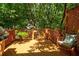 Cozy deck with wood railings, lattice accents, comfortable seating, and shade trees overhead at 630 Cleburne Ne Ter, Atlanta, GA 30306