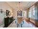 Elegant dining room featuring hardwood floors, coffered ceiling, an accent wall and large windows at 630 Cleburne Ne Ter, Atlanta, GA 30306